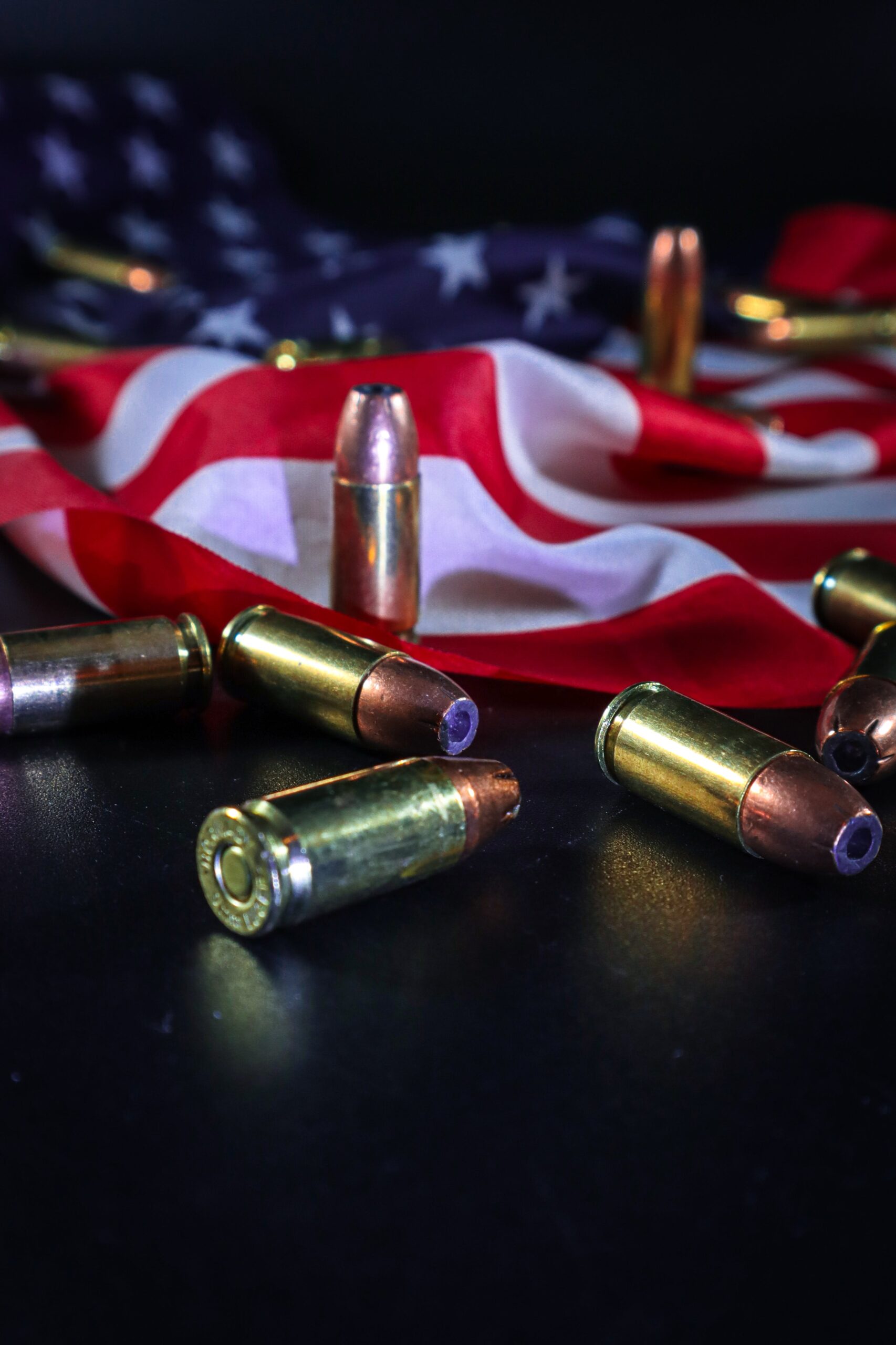 Bullet shells and an american flag on a black background