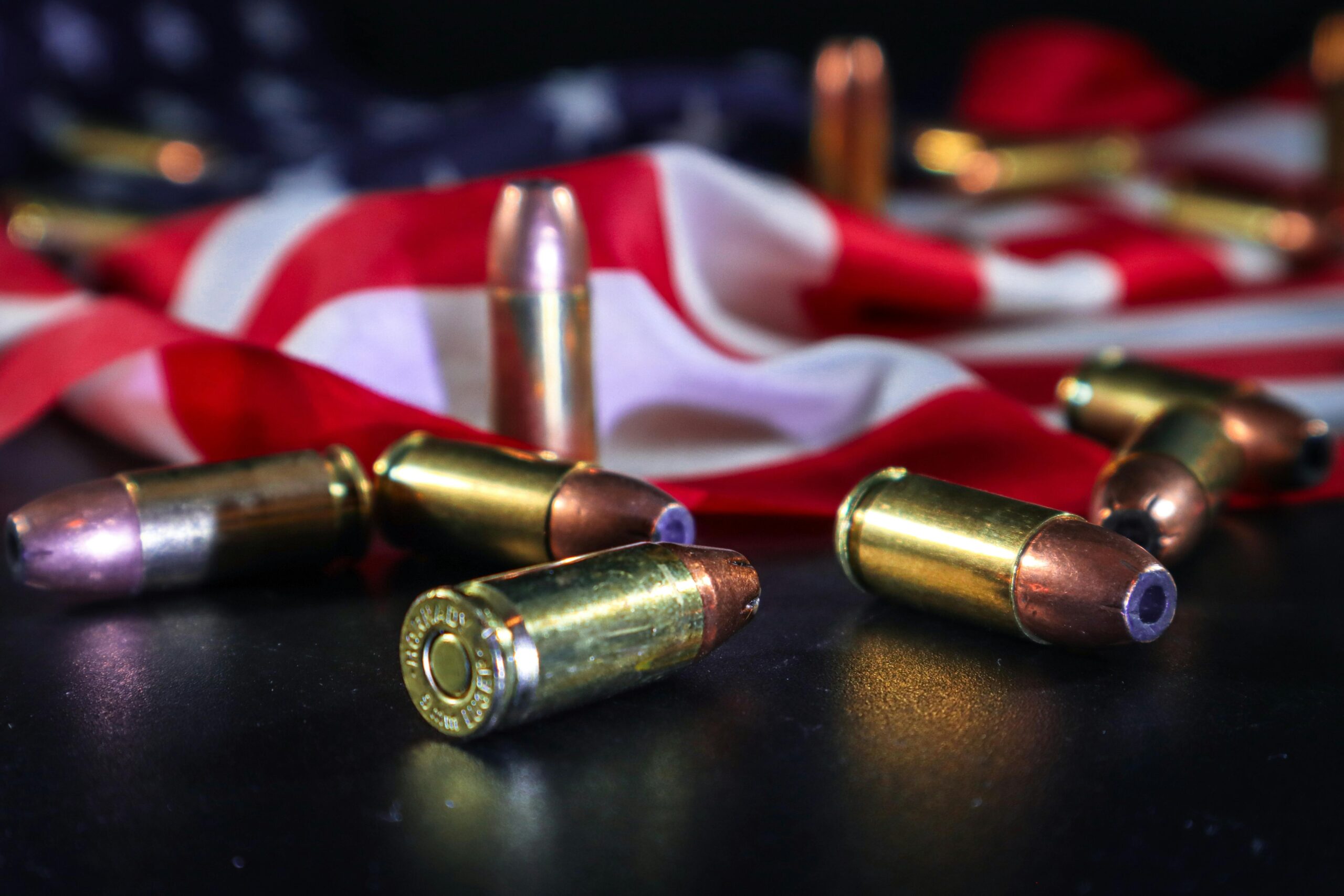 Bullet shells and an american flag on a black background