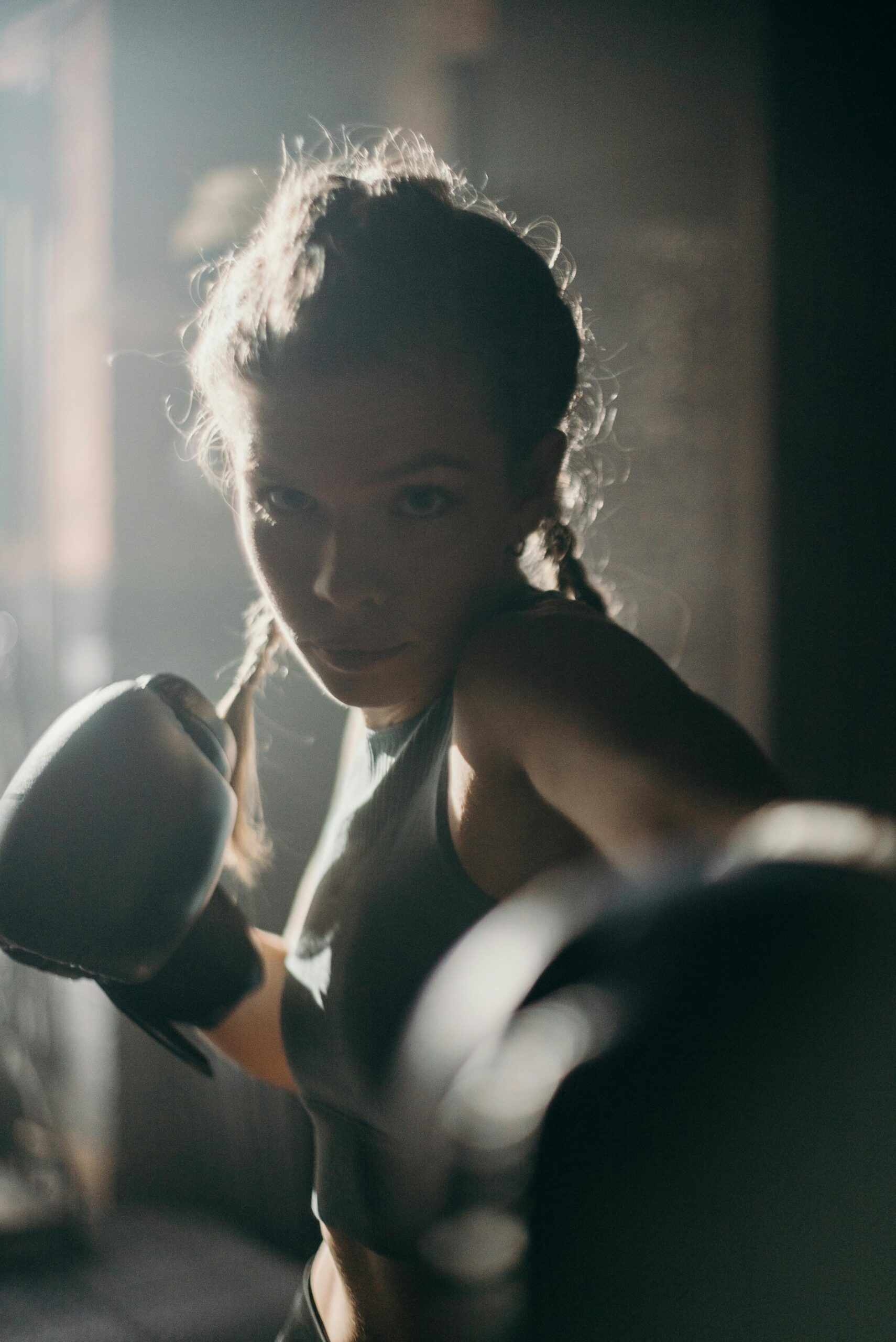 Woman in Black Brassiere Holding Black Kettle Bell